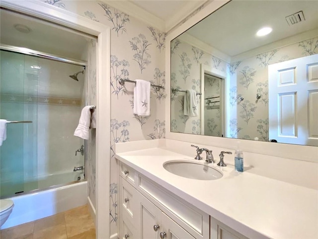 full bathroom with tile patterned flooring, bath / shower combo with glass door, vanity, and toilet