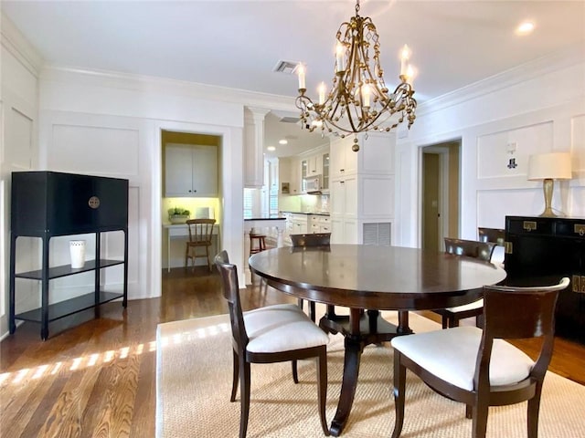 dining room with ornamental molding and dark hardwood / wood-style floors