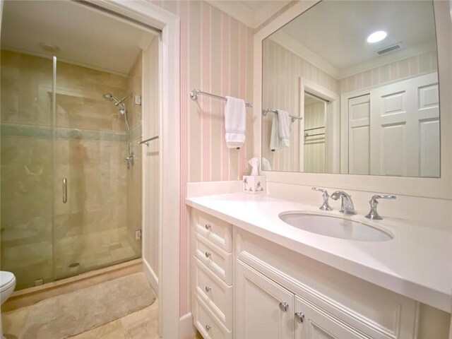 bathroom featuring vanity, an enclosed shower, and toilet