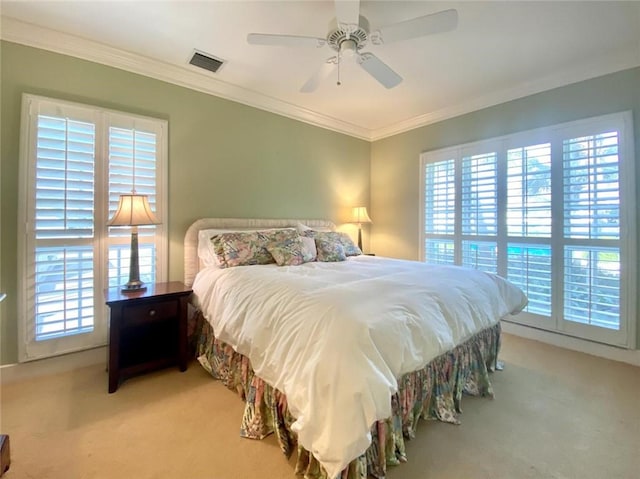 bedroom with light colored carpet, ornamental molding, and multiple windows