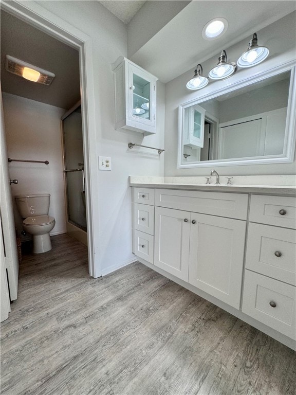 bathroom featuring hardwood / wood-style flooring, vanity, and toilet