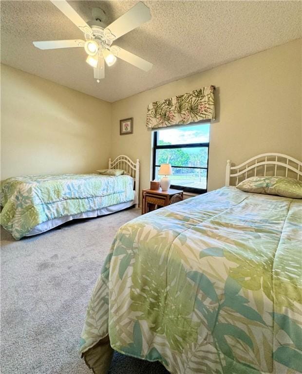 carpeted bedroom with a textured ceiling and ceiling fan