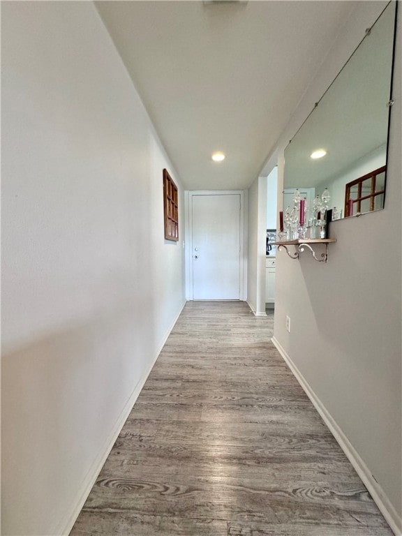 hallway with light hardwood / wood-style floors