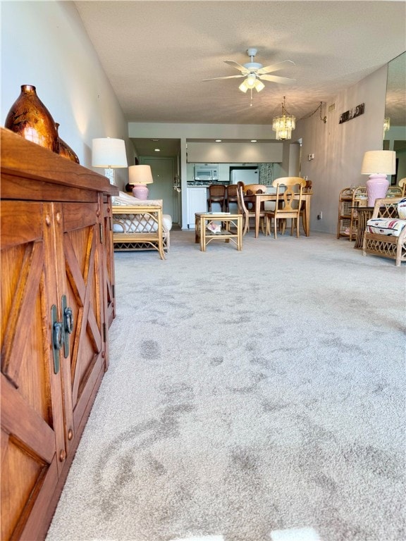 interior space featuring ceiling fan with notable chandelier