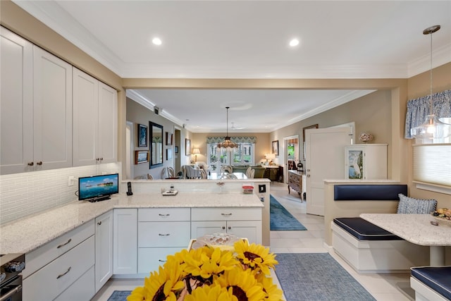 kitchen featuring white cabinetry, breakfast area, decorative light fixtures, and light tile patterned floors