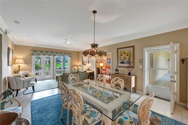 tiled dining room with a chandelier, french doors, and crown molding