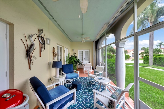 sunroom with a healthy amount of sunlight and ceiling fan