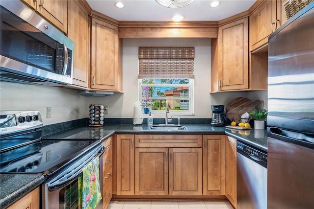 kitchen featuring appliances with stainless steel finishes, recessed lighting, a sink, and brown cabinets