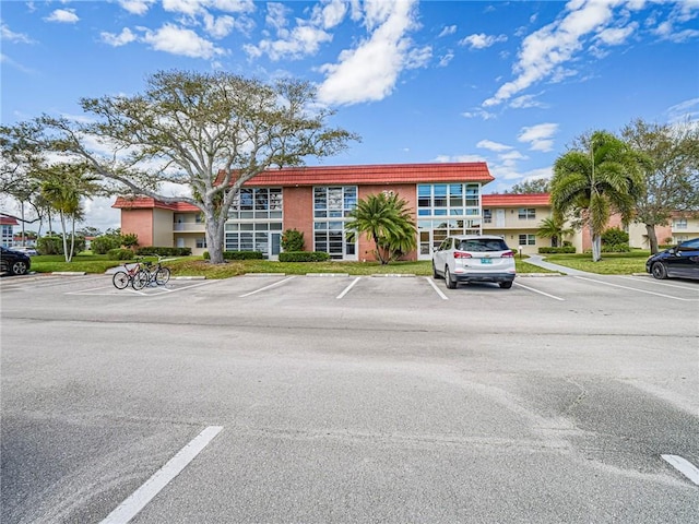 62 Woodland Dr Unit 201, Vero Beach, FL 32962 - view of building exterior with uncovered parking