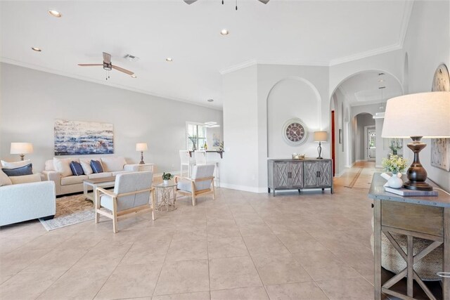 tiled living room with ceiling fan, a healthy amount of sunlight, and crown molding