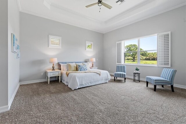 bedroom featuring carpet, a tray ceiling, ceiling fan, and ornamental molding