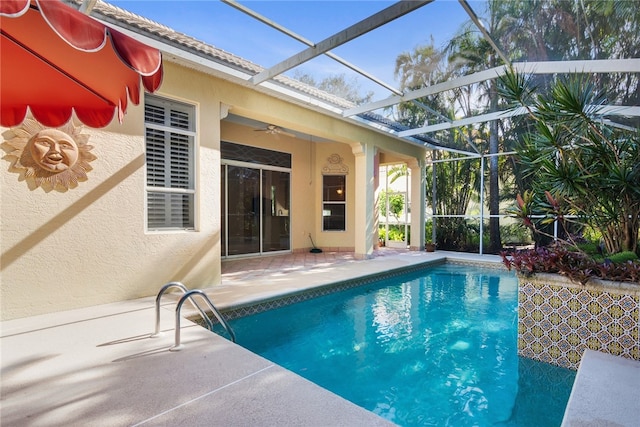 view of pool featuring a lanai, a patio, and ceiling fan