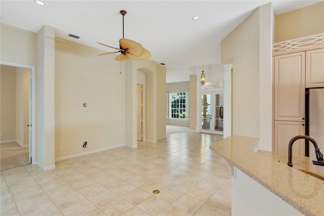 kitchen featuring light stone counters, recessed lighting, visible vents, and light brown cabinets