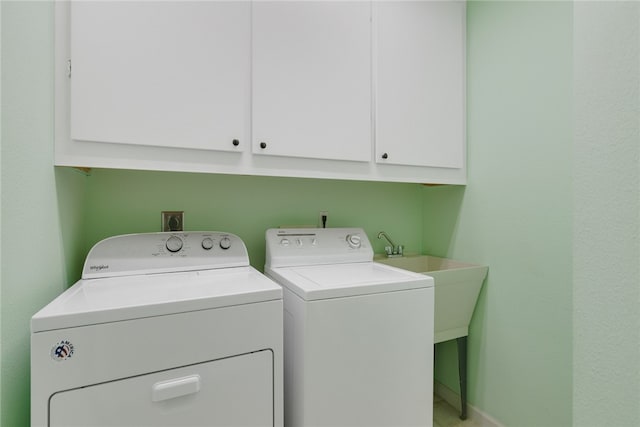 laundry room with cabinets and washing machine and clothes dryer