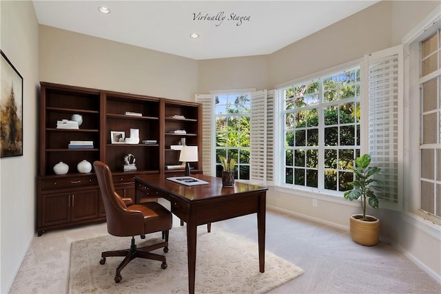 home office with plenty of natural light and light colored carpet