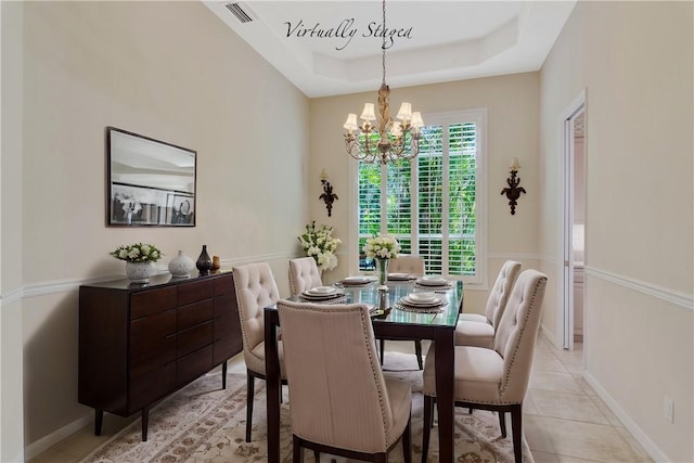 839 Island Club Sq, Vero Beach, FL 32963 - dining space with a chandelier, a raised ceiling, and light tile patterned floors