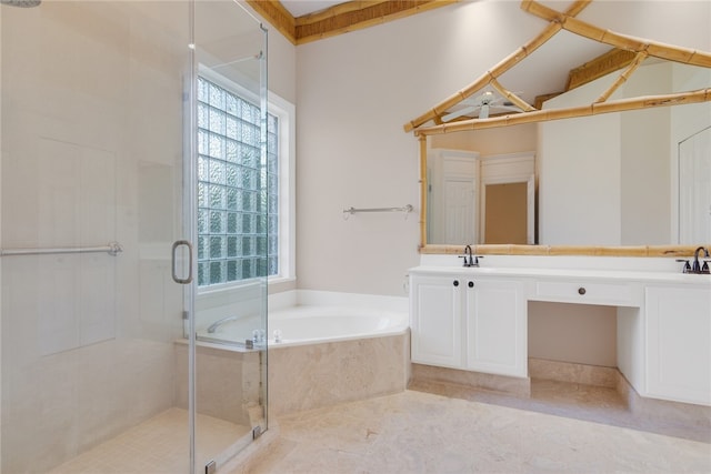 bathroom featuring a healthy amount of sunlight, a garden tub, and a shower stall