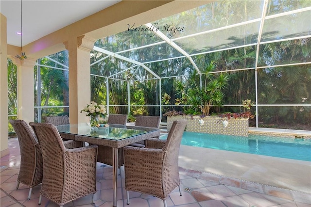 outdoor pool with a patio area, glass enclosure, and outdoor dining space