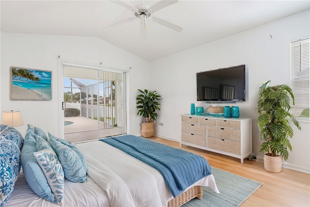 bedroom featuring access to exterior, light hardwood / wood-style floors, ceiling fan, and lofted ceiling