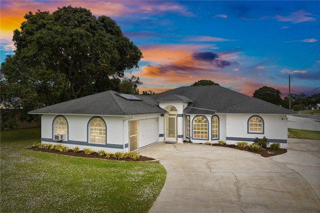 view of front of house featuring a lawn and a garage