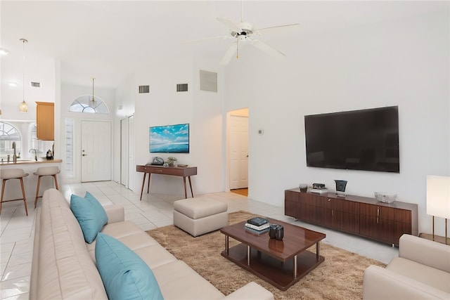 tiled living room featuring high vaulted ceiling and ceiling fan