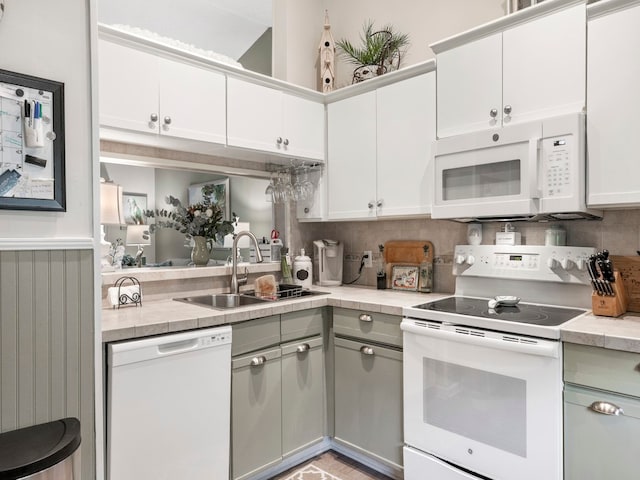 kitchen featuring white cabinets, white appliances, and sink