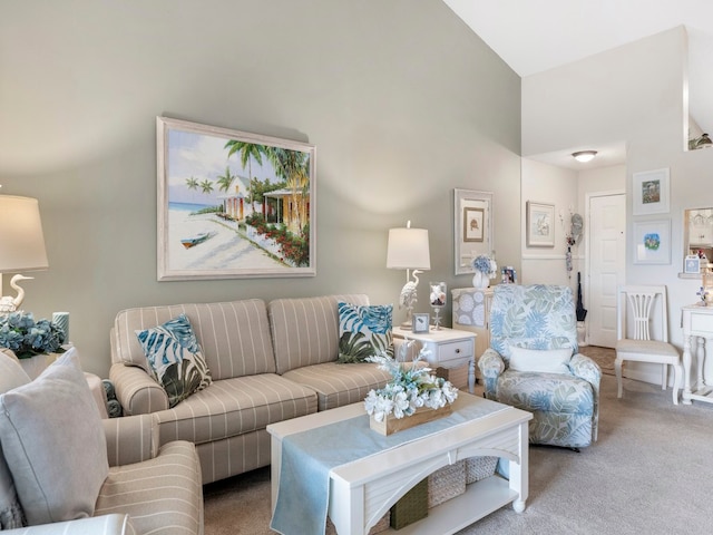 carpeted living room featuring high vaulted ceiling