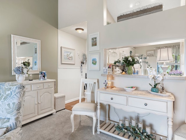 bathroom featuring a textured ceiling and high vaulted ceiling