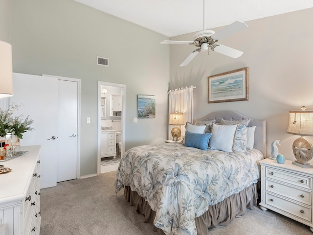 carpeted bedroom featuring connected bathroom, high vaulted ceiling, and ceiling fan