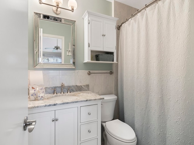 bathroom with ceiling fan, vanity, and toilet