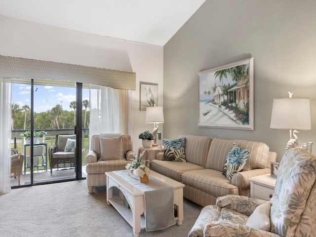 living room featuring carpet and vaulted ceiling