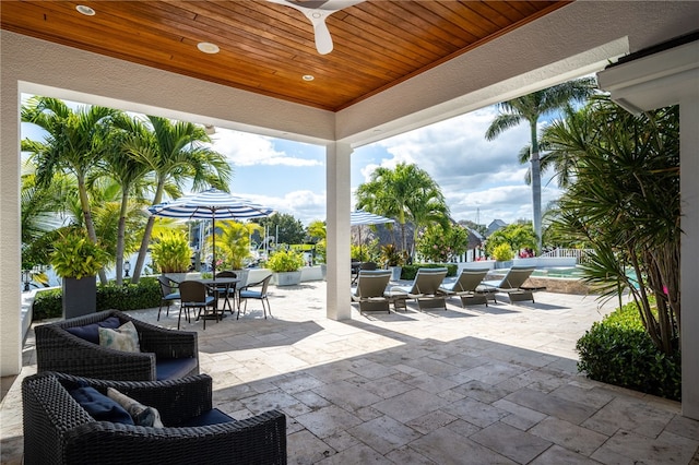 view of patio with outdoor dining space and ceiling fan