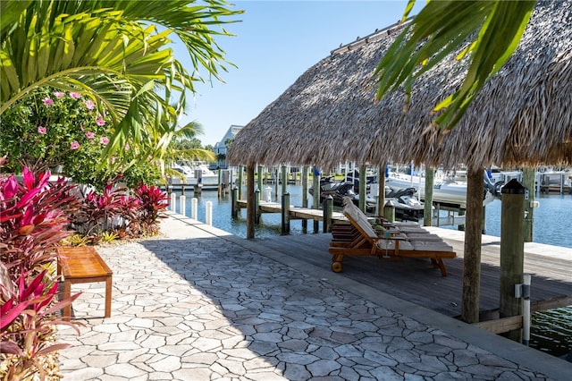 dock area featuring boat lift and a water view