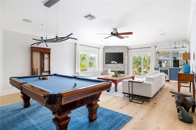 rec room with healthy amount of natural light, light wood-style floors, crown molding, ceiling fan, and pool table