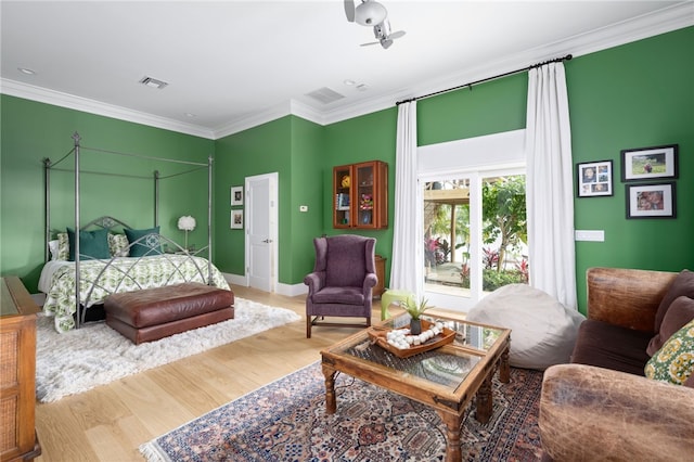 bedroom featuring wood finished floors, ornamental molding, access to exterior, and baseboards