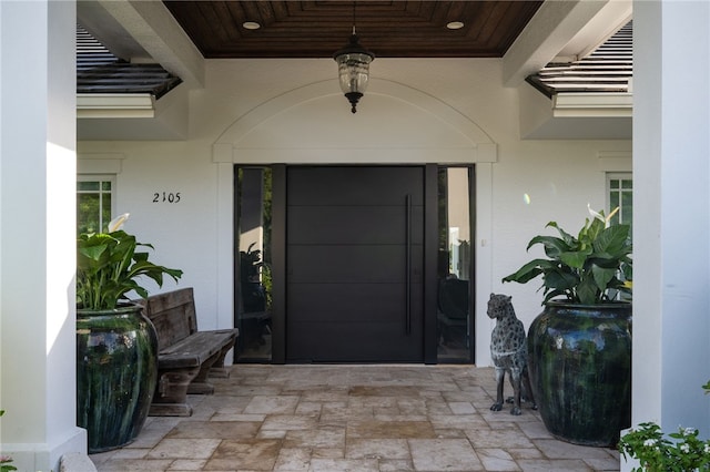 property entrance with stucco siding