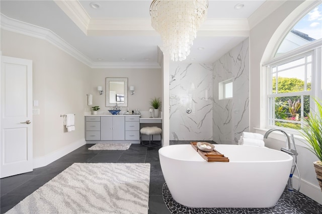 full bath featuring vanity, a chandelier, a soaking tub, a tray ceiling, and crown molding