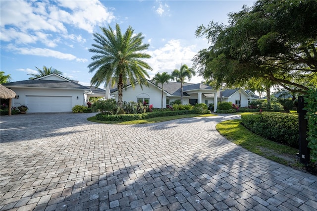 view of front of house featuring decorative driveway and a garage