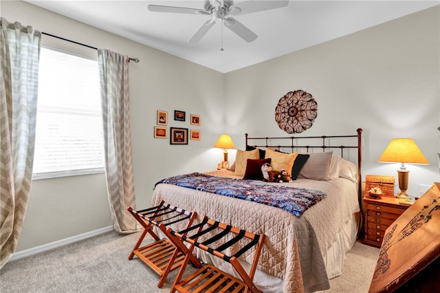 bedroom with light carpet, multiple windows, and ceiling fan