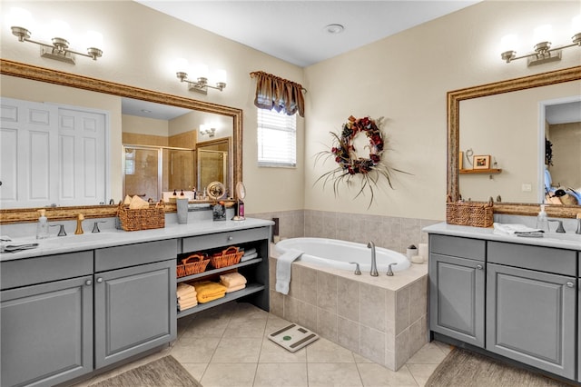 bathroom with tile patterned flooring, vanity, and separate shower and tub