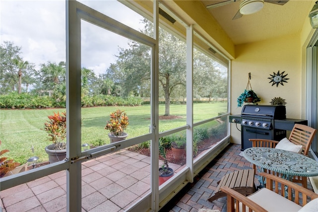 sunroom featuring ceiling fan