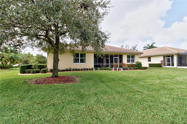 ranch-style house with a front lawn and a sunroom