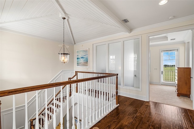 hallway featuring ornamental molding, wood ceiling, dark wood-type flooring, lofted ceiling with beams, and a notable chandelier