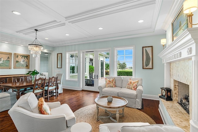 living room featuring a premium fireplace, dark hardwood / wood-style flooring, a chandelier, and coffered ceiling