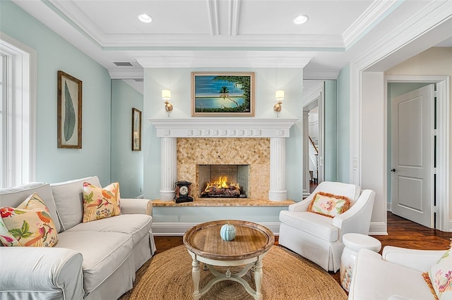 living room featuring wood-type flooring, crown molding, and a premium fireplace