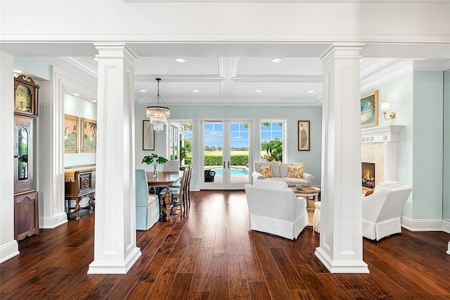 foyer with a high end fireplace, french doors, a notable chandelier, beamed ceiling, and dark hardwood / wood-style floors