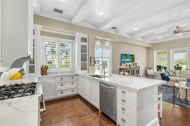 kitchen featuring kitchen peninsula, white cabinetry, dishwasher, and light stone counters