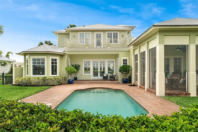 back of property with french doors, a patio, a balcony, and ceiling fan