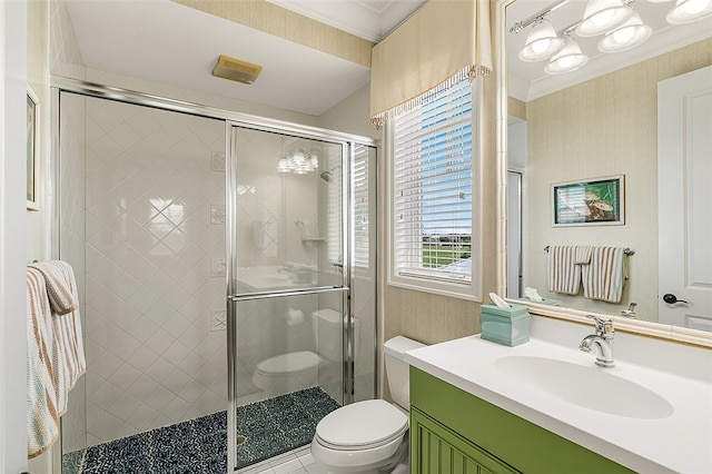 bathroom with crown molding, vanity, a shower with shower door, and toilet