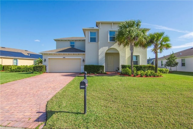 mediterranean / spanish-style home featuring a front lawn and a garage